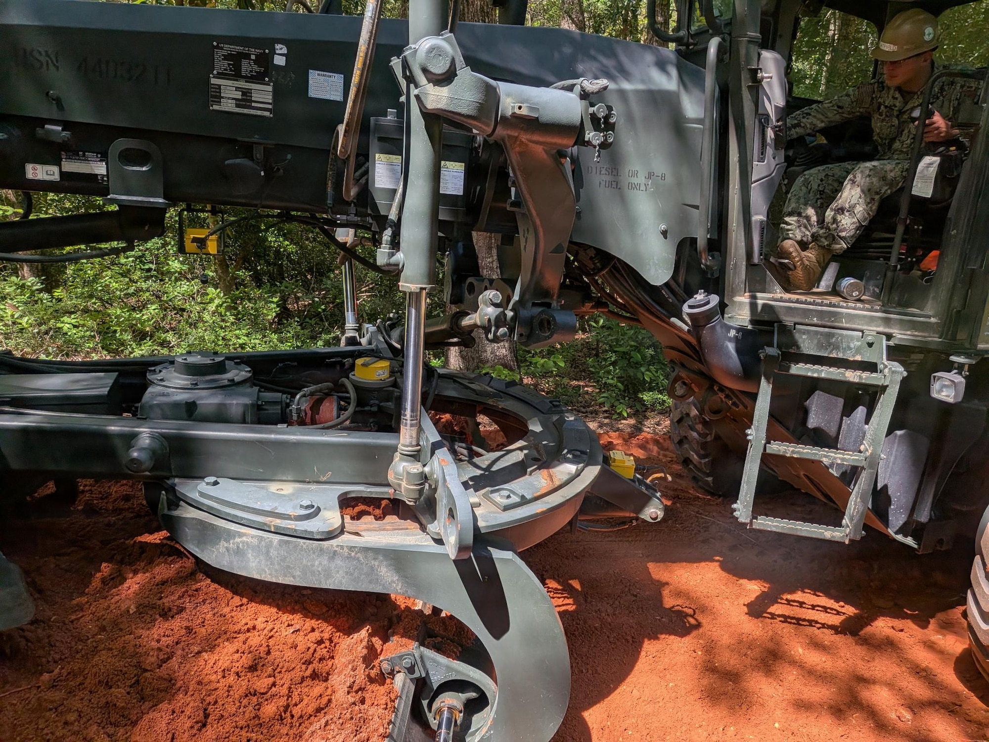 Sailor operates machinery during clearing