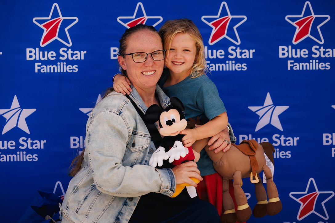 A mother and daughter pose for a photo together.