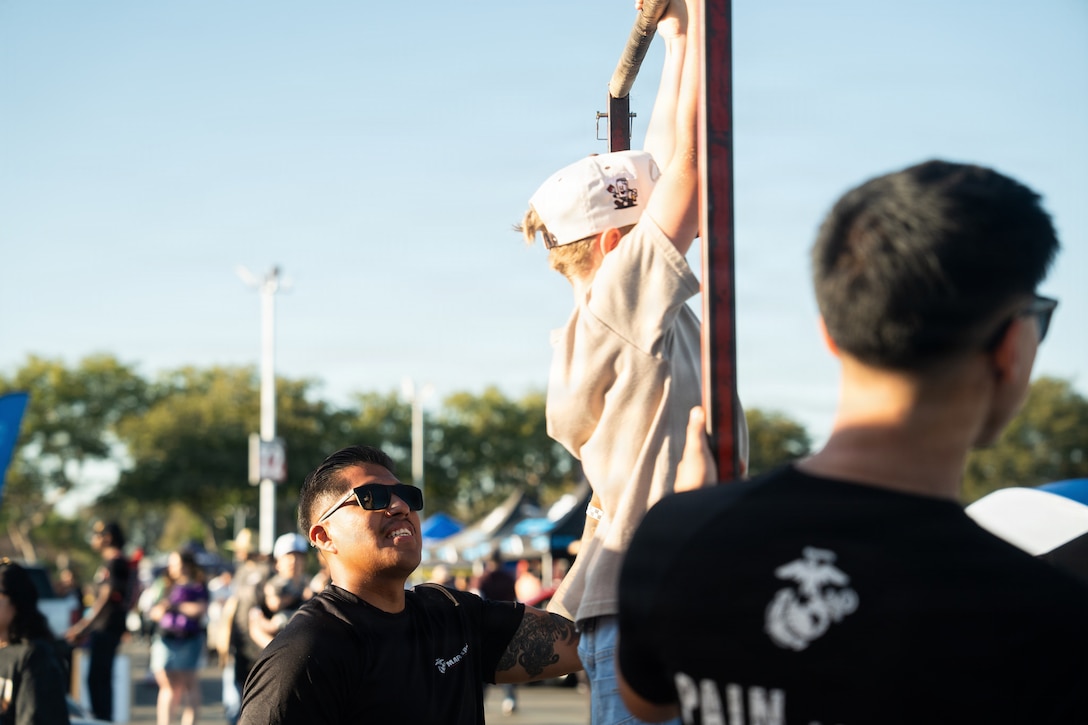 U.S. Marines with Recruiting Station Orange County oversee a Marine Corps pull-up challenge during FuelFest in Costa Mesa, California, June 13, 2026. FuelFest is an annual event featuring a large-scale car show with live-action drifting, music, and pop culture. (U.S. Marine Corps photo by Sgt. Francisco Angel)