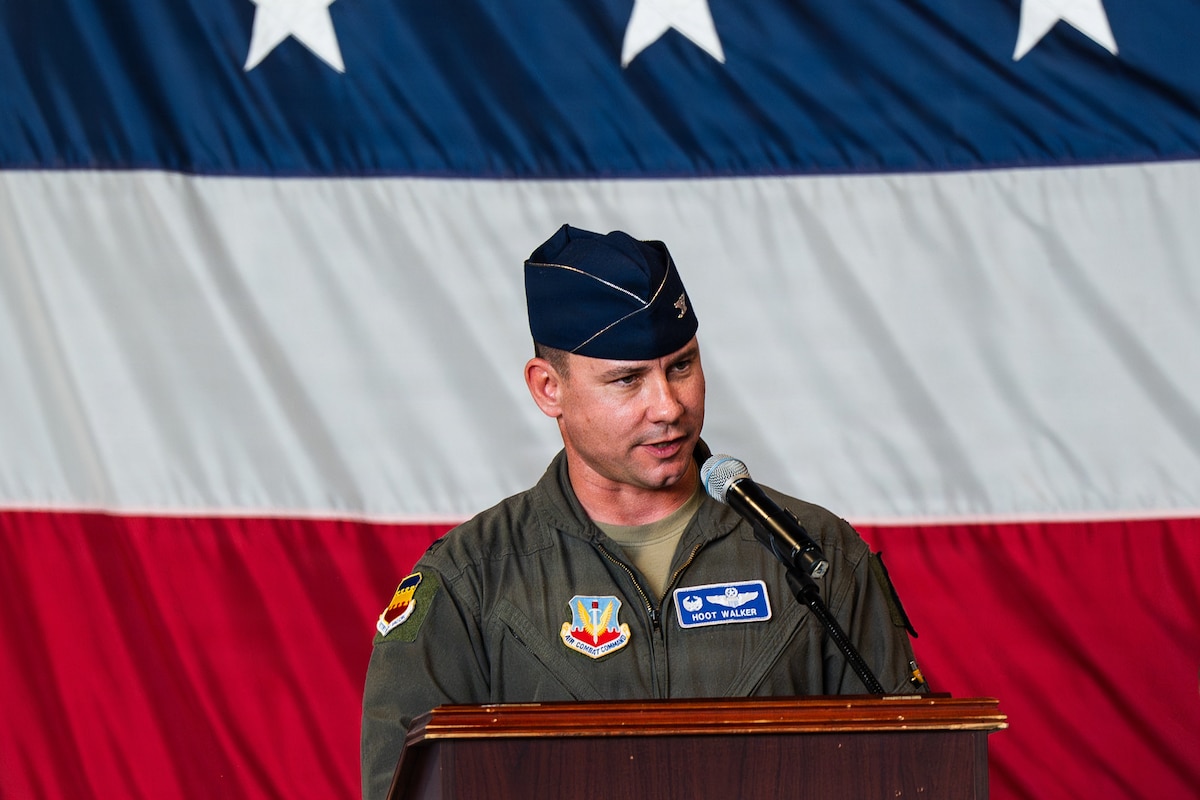 A pilot gives a speech at a podium