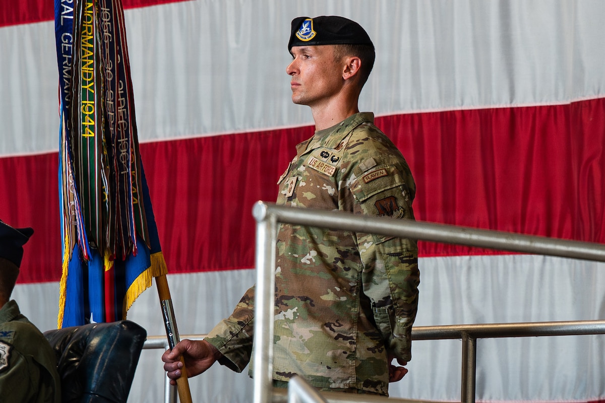 An Airman holds a guidon
