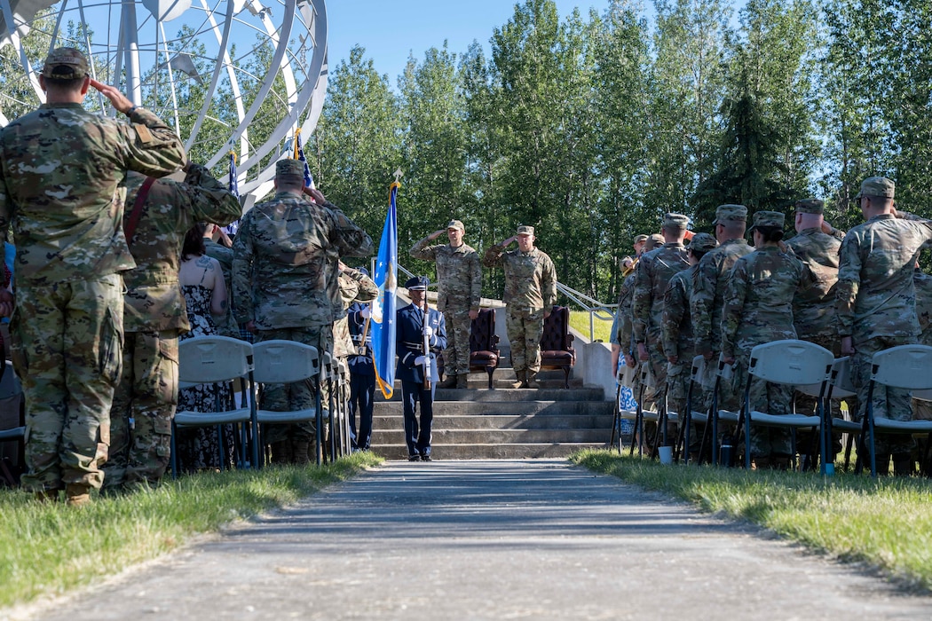 Airmen from the 354th Fighter Wing render salutes during the national anthem at an assumption of responsibility ceremony at Eielson Air Force Base, Alaska, July 2, 2026.