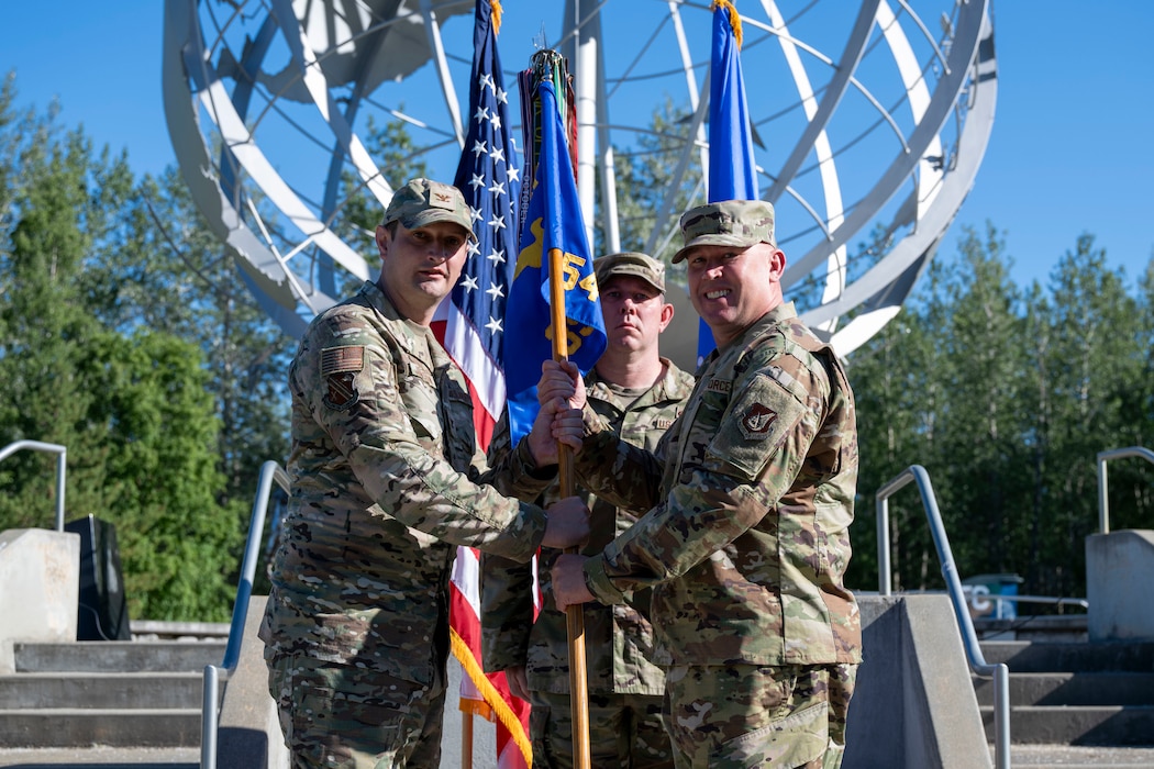 U.S. Air Force Chief Master Sgt. Ian Neske, right, assumes responsibility as the new command chief of the 354th Fighter Wing from U.S. Air Force Col. Matthew Johnston, 354th FW commander, during an assumption of responsibility ceremony at Eielson Air Force Base, Alaska, July 2, 2026.