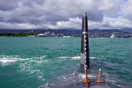 The Virginia-class fast-attack submarine USS Illinois (SSN 786) is towed following un-docking at Pearl Harbor Naval Shipyard and Intermediate Maintenance Facility, June 24, 2026.