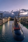 Virginia-class fast-attack submarine USS Illinois (SSN 786) awaits undocking from Dry Dock 2 at Pearl Harbor Naval Shipyard and Intermediate Maintenance Facility (PHNSY & IMF) during the pre-dawn hours June 24, 2026. Commissioned Oct. 29, 2016, Illinois is the 13th Virginia-class submarine. It is the second U.S. Navy ship to be named for the state of Illinois. Illinois is assigned to Submarine Squadron 1 and is capable of supporting various missions, including anti-submarine warfare; anti-surface ship warfare; strike warfare; special operations forces support; and intelligence, surveillance, and reconnaissance. PHNSY & IMF’s mission is to keep the Navy’s fleet “Fit to Fight" by repairing, maintaining, and modernizing the Navy's fast-attack submarines and surface ships. Strategically located in the heart of the Pacific, it is the most comprehensive fleet repair and maintenance facility between the U.S. West Coast and the Far East. (U.S. Navy photo by Kenny Jones)