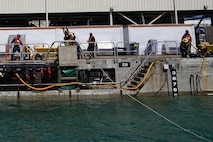 Riggers with Pearl Harbor Naval Shipyard and Intermediate Maintenance Facility (PHNSY & IMF) handle control lines during the undocking of USS Illinois (SSN 786) at Joint Base Pearl Harbor-Hickam, June 24, 2026. The Virginia-class fast-attack submarine left Dry Dock 2 at PHNSY & IMF, completing an important milestone in the submarine’s scheduled lifecycle maintenance period. Commissioned Oct. 29, 2016, Illinois is the 13th Virginia-class submarine. It is the second U.S. Navy ship to be named for the state of Illinois. Illinois is assigned to Submarine Squadron 1 and is capable of supporting various missions, including anti-submarine warfare; anti-surface ship warfare; strike warfare; special operations forces support; and intelligence, surveillance, and reconnaissance. PHNSY & IMF’s mission is to keep the Navy’s fleet “Fit to Fight" by repairing, maintaining, and modernizing the Navy's fast-attack submarines and surface ships. Strategically located in the heart of the Pacific, it is the most comprehensive fleet repair and maintenance facility between the U.S. West Coast and the Far East. (U.S. Navy photo by Claudia LaMantia)