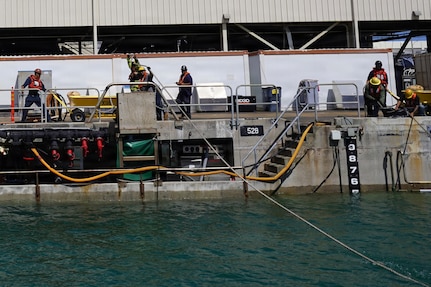 Riggers with Pearl Harbor Naval Shipyard and Intermediate Maintenance Facility (PHNSY & IMF) handle control lines during the undocking of USS Illinois (SSN 786) at Joint Base Pearl Harbor-Hickam, June 24, 2026. The Virginia-class fast-attack submarine left Dry Dock 2 at PHNSY & IMF, completing an important milestone in the submarine’s scheduled lifecycle maintenance period. Commissioned Oct. 29, 2016, Illinois is the 13th Virginia-class submarine. It is the second U.S. Navy ship to be named for the state of Illinois. Illinois is assigned to Submarine Squadron 1 and is capable of supporting various missions, including anti-submarine warfare; anti-surface ship warfare; strike warfare; special operations forces support; and intelligence, surveillance, and reconnaissance. PHNSY & IMF’s mission is to keep the Navy’s fleet “Fit to Fight" by repairing, maintaining, and modernizing the Navy's fast-attack submarines and surface ships. Strategically located in the heart of the Pacific, it is the most comprehensive fleet repair and maintenance facility between the U.S. West Coast and the Far East. (U.S. Navy photo by Claudia LaMantia)