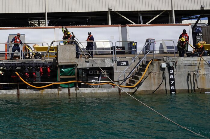 Riggers with Pearl Harbor Naval Shipyard and Intermediate Maintenance Facility (PHNSY & IMF) handle control lines during the undocking of USS Illinois (SSN 786) at Joint Base Pearl Harbor-Hickam, June 24, 2026. The Virginia-class fast-attack submarine left Dry Dock 2 at PHNSY & IMF, completing an important milestone in the submarine’s scheduled lifecycle maintenance period. Commissioned Oct. 29, 2016, Illinois is the 13th Virginia-class submarine. It is the second U.S. Navy ship to be named for the state of Illinois. Illinois is assigned to Submarine Squadron 1 and is capable of supporting various missions, including anti-submarine warfare; anti-surface ship warfare; strike warfare; special operations forces support; and intelligence, surveillance, and reconnaissance. PHNSY & IMF’s mission is to keep the Navy’s fleet “Fit to Fight" by repairing, maintaining, and modernizing the Navy's fast-attack submarines and surface ships. Strategically located in the heart of the Pacific, it is the most comprehensive fleet repair and maintenance facility between the U.S. West Coast and the Far East. (U.S. Navy photo by Claudia LaMantia)