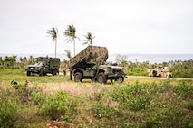 From left, a Mobile Command Vehicle, a Navy-Marine Expeditionary Ship Interdiction System and a Marine Air Defense Integrated System, all assigned to 3rd Marine Littoral Regiment, 3rd Marine Division, conduct a simulated NMESIS firing mission during KAMANDAG 10 at Calayan, Philippines, June 25, 2026.