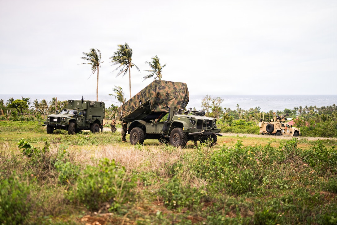 From left, a Mobile Command Vehicle, a Navy-Marine Expeditionary Ship Interdiction System and a Marine Air Defense Integrated System, all assigned to 3rd Marine Littoral Regiment, 3rd Marine Division, conduct a simulated NMESIS firing mission during KAMANDAG 10 at Calayan, Philippines, June 25, 2026. KAMANDAG 10 is a multi-domain, joint, and combined exercise between the Armed Forces of the Philippines and United States military focused on enhancing maritime security, interoperability, contested logistics, and combined readiness throughout the Philippine archipelago. (U.S. Marine Corps photo by 2nd Lt. John Kim)