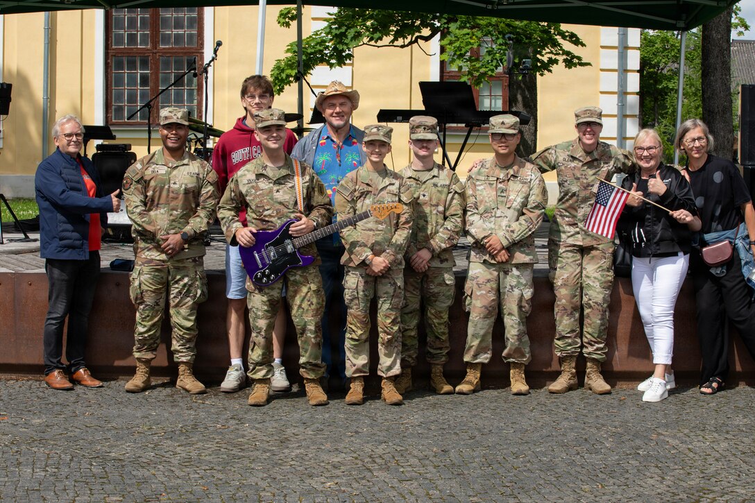 U.S. Soldiers assigned to the 1st Infantry Division Band, pose for a photo with Estonian locals after their U.S. Independence Day concert during the South-Estonia Rally in Võru, Estonia, July 4, 2026. The performance honored the United States' 250th anniversary of independence and celebrated the enduring partnership between the United States and Estonia while connecting audiences through music. V Corps is the U.S. Army's only forward-deployed corps, serving as the senior tactical headquarters for Army forces in Eastern Europe to deter conflict and provide combat-ready forces alongside our NATO Allies. V Corps is operationalizing and expanding the Eastern Flank Deterrence Initiative with Allies, rapidly integrating emerging technologies into training and tactical plans. (U.S. Army photo by Staff Sgt. Olivia Lauer, 196th Mobile Public Affairs Detachment)
