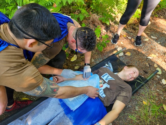 BREMERTON, Wash. – Sailors assigned to Naval Readiness and Training Command Bremerton treat a simulated casualty during the inaugural 2026 Corpsman Cup held Thursday, June 18, 2026. The high-adrenaline, 45-minute continuous tactical medical course challenged teams across five intense stations designed to test their teamwork, esprit de corps, and Tactical Combat Casualty Care (TCCC) skills under intense pressure. Teams tackled the course in staggered 20-minute intervals to prove operational readiness and kick off the summer season. (U.S. Navy photo by Mass Communication Specialist 1st Class Jennifer Benedict, NHB/NMRTC Bremerton Public Affairs.)