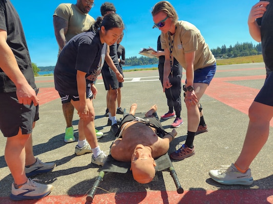 BREMERTON, Wash. – Sailors assigned to Naval Readiness and Training Command Bremerton treat a simulated casualty during the inaugural 2026 Corpsman Cup held Thursday, June 18, 2026. The high-adrenaline, 45-minute continuous tactical medical course challenged teams across five intense stations designed to test their teamwork, esprit de corps, and Tactical Combat Casualty Care (TCCC) skills under intense pressure. Teams tackled the course in staggered 20-minute intervals to prove operational readiness and kick off the summer season. (U.S. Navy photo by Mass Communication Specialist 1st Class Jennifer Benedict, NHB/NMRTC Bremerton Public Affairs.)