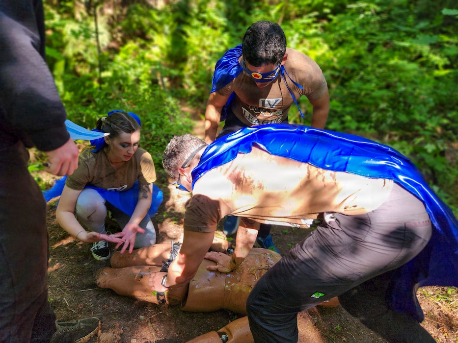 260618-N-QW460-1254 BREMERTON, Wash. – Sailors assigned to Naval Readiness and Training Command Bremerton treat a simulated casualty during the inaugural 2026 Corpsman Cup held Thursday, June 18, 2026. The high-adrenaline, 45-minute continuous tactical medical course challenged teams across five intense stations designed to test their teamwork, esprit de corps, and Tactical Combat Casualty Care (TCCC) skills under intense pressure. Teams tackled the course in staggered 20-minute intervals to prove operational readiness and kick off the summer season. (U.S. Navy photo by Mass Communication Specialist 1st Class Jennifer Benedict, NHB/NMRTC Bremerton Public Affairs.)