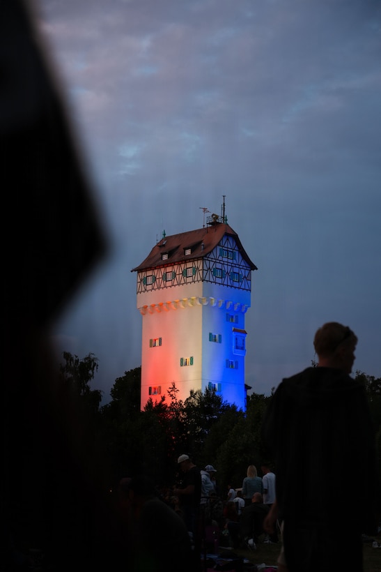 Grafenwoehr's historic water tower is lit in red, white and blue in Grafenwoehr, Germany, July 4, 2026. The Freedom 250 Fest was held in observance of Independence Day and to commemorate America's 250th birthday. It honors the nation's enduring legacy of freedom and service. (U.S. Army photo by Sgt. Kammen Taylor)