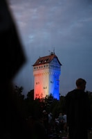 Grafenwoehr's historic water tower is lit in red, white and blue in Grafenwoehr, Germany, July 4, 2026. The Freedom 250 Fest was held in observance of Independence Day and to commemorate America's 250th birthday. It honors the nation's enduring legacy of freedom and service. (U.S. Army photo by Sgt. Kammen Taylor)