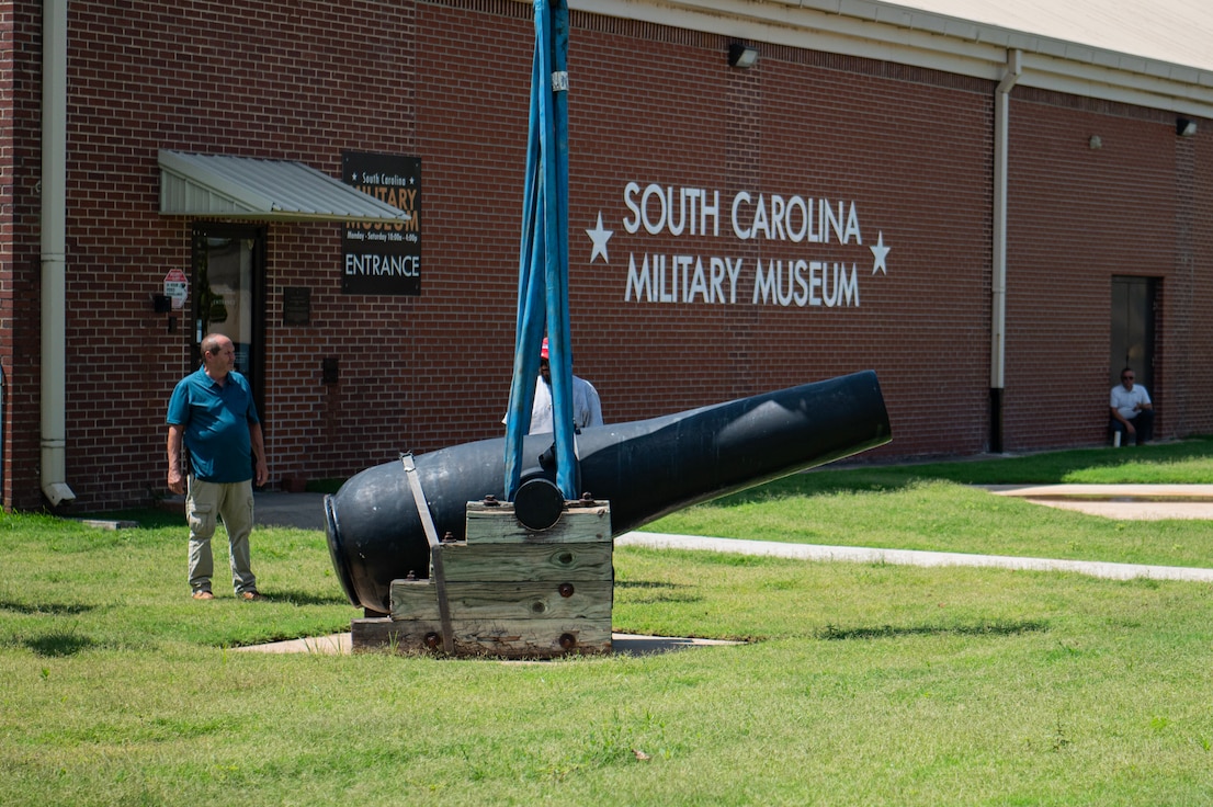 crane lowering cannon in front of south carolina military museum