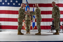 U.S. Air Force Col. Jimmy Schlabach, 91st Missile Wing commander, left, relinquishes the guidon to U.S. Air Force Col. George Hern 91st Security Forces Group (SFG) incoming commander, during a change of command ceremony at Minot Air Force Base, North Dakota, July 1, 2026. Hern will ensure that the 91st SFG is trained, organized and equipped to secure 150 Minuteman III missiles, launch facilities and 15 Missile Alert Facilities geographically separated throughout 8,500 square miles.