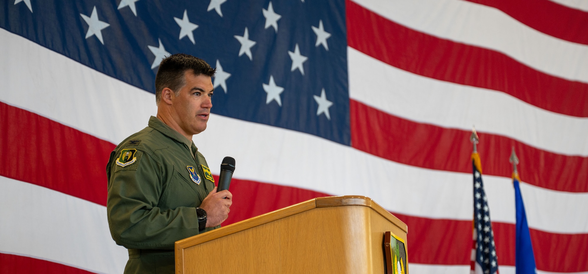 U.S. Air Force Col. Bryson Ayers, 5th operational Group incoming commander, gives remarks during a change of command ceremony at Minot Air Force base, North Dakota, July 7, 2026. As the incoming commander, Ayers will be directly responsible for the people who fly the B-52's at Minot, making sure aircraft, crews and operational systems are prepared, certified and ready to execute the nation's strategic bomber mission at any time.