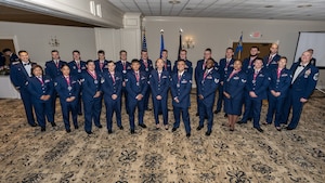 A large group photo of men and women wearing formal blue military uniforms