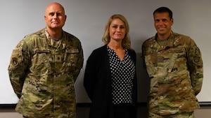 Three members of IG pose for a photo.