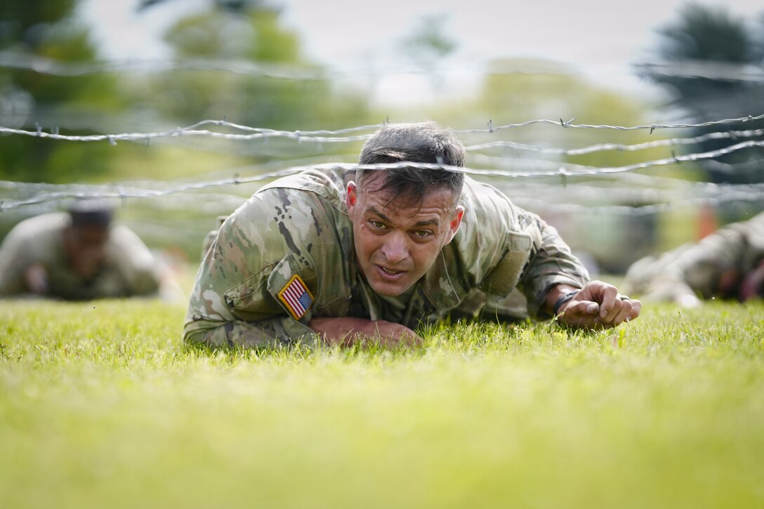 An Army Reserve Best Squad competitor low crawls while completing a physical fitness assessment at Fort McCoy Wisconsin, May 23, 2026. One hundred Soldiers from around the nation are competing in the 2026 BSC, an annual competition that brings together the best Soldiers and squads from across the U.S. Army Reserve to earn the title of “Best Warrior” and “Best Squad” among their peers. (U.S. Army Reserve photo by Master Sgt. Crystal Harlow)