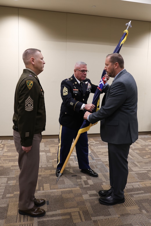 Transfer of responsibility to the new Command Sergeant Major,  Michael A. Ringman as its new senior enlisted leader during an Assumption of Responsibility ceremony.