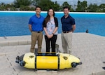 Members of the Mission Effectiveness & Assessment with Subsea Recognition (MEASUR) team (from left) Dr. Spencer Chang, Dr. Adriana McKinney and Dr. Tony Diaz, are shown with the Science & Technology Engineering Innovation Vehicle, or STEIV, at NSWC Panama City Division’s test pond. By equipping unmanned underwater vehicles with advanced sensors and artificial intelligence, MEASUR automatically and accurately evaluates physical damage to underwater threats. (Not pictured) Dr. Kwang Lee, Peter Romaine and Dr. Minh Chau. (U.S. Navy photo by Ronnie Newsome)