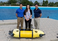 Members of the Mission Effectiveness & Assessment with Subsea Recognition (MEASUR) team (from left) Dr. Spencer Chang, Dr. Adriana McKinney and Dr. Tony Diaz, are shown with the Science & Technology Engineering Innovation Vehicle, or STEIV, at NSWC Panama City Division’s test pond. By equipping unmanned underwater vehicles with advanced sensors and artificial intelligence, MEASUR automatically and accurately evaluates physical damage to underwater threats. (Not pictured) Dr. Kwang Lee, Peter Romaine and Dr. Minh Chau. (U.S. Navy photo by Ronnie Newsome)
