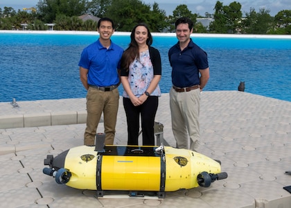 Members of the Mission Effectiveness & Assessment with Subsea Recognition (MEASUR) team (from left) Dr. Spencer Chang, Dr. Adriana McKinney and Dr. Tony Diaz, are shown with the Science & Technology Engineering Innovation Vehicle, or STEIV, at NSWC Panama City Division’s test pond. By equipping unmanned underwater vehicles with advanced sensors and artificial intelligence, MEASUR automatically and accurately evaluates physical damage to underwater threats. (Not pictured) Dr. Kwang Lee, Peter Romaine and Dr. Minh Chau. (U.S. Navy photo by Ronnie Newsome)