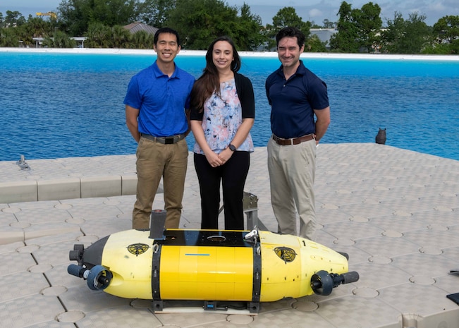 Members of the Mission Effectiveness & Assessment with Subsea Recognition (MEASUR) team (from left) Dr. Spencer Chang, Dr. Adriana McKinney and Dr. Tony Diaz, are shown with the Science & Technology Engineering Innovation Vehicle, or STEIV, at NSWC Panama City Division’s test pond. By equipping unmanned underwater vehicles with advanced sensors and artificial intelligence, MEASUR automatically and accurately evaluates physical damage to underwater threats. (Not pictured) Dr. Kwang Lee, Peter Romaine and Dr. Minh Chau. (U.S. Navy photo by Ronnie Newsome)