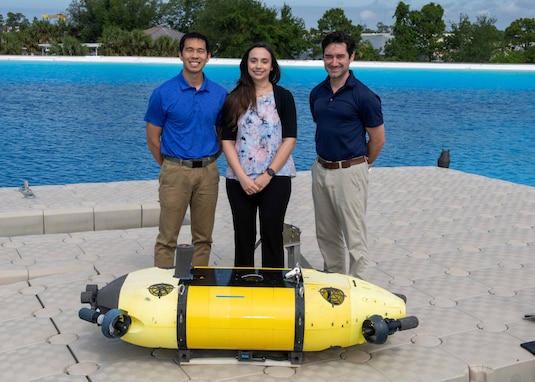 Members of the Mission Effectiveness & Assessment with Subsea Recognition (MEASUR) team (from left) Dr. Spencer Chang, Dr. Adriana McKinney and Dr. Tony Diaz, are shown with the Science & Technology Engineering Innovation Vehicle, or STEIV, at NSWC Panama City Division’s test pond. By equipping unmanned underwater vehicles with advanced sensors and artificial intelligence, MEASUR automatically and accurately evaluates physical damage to underwater threats. (Not pictured) Dr. Kwang Lee, Peter Romaine and Dr. Minh Chau. (U.S. Navy photo by Ronnie Newsome)