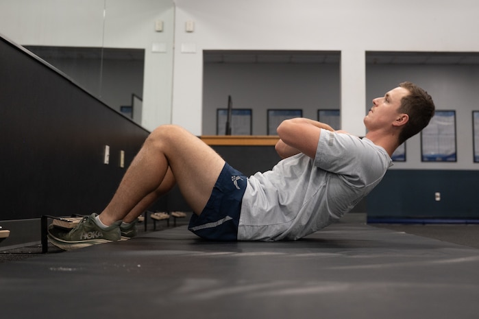 A U.S. Airmen performs a sit-up.