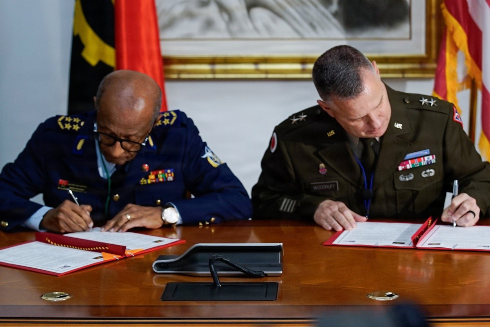U.S. Army Maj. Gen. Matthew S. Woodruff, right, adjutant general for the Ohio National Guard, and Angolan Aviation Gen. Altino Carlos José dos Santos, left, chief of the General Staff of the Angolan Armed Forces, sign a Department of War National Guard Bureau State Partnership Program agreement prior to the 2026 African Chiefs of Defense Conference in Luanda, Angola, June 29, 2026.