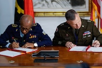 U.S. Army Maj. Gen. Matthew S. Woodruff, right, adjutant general for the Ohio National Guard, and Angolan Aviation Gen. Altino Carlos José dos Santos, left, chief of the General Staff of the Angolan Armed Forces, sign a Department of War National Guard Bureau State Partnership Program agreement prior to the 2026 African Chiefs of Defense Conference in Luanda, Angola, June 29, 2026.