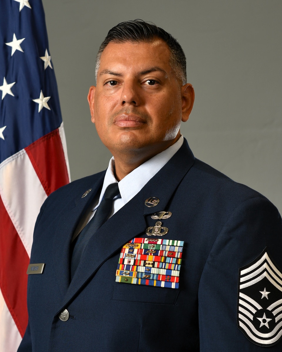 photo of Chief Jamie Wiesner standing in front of a US flag