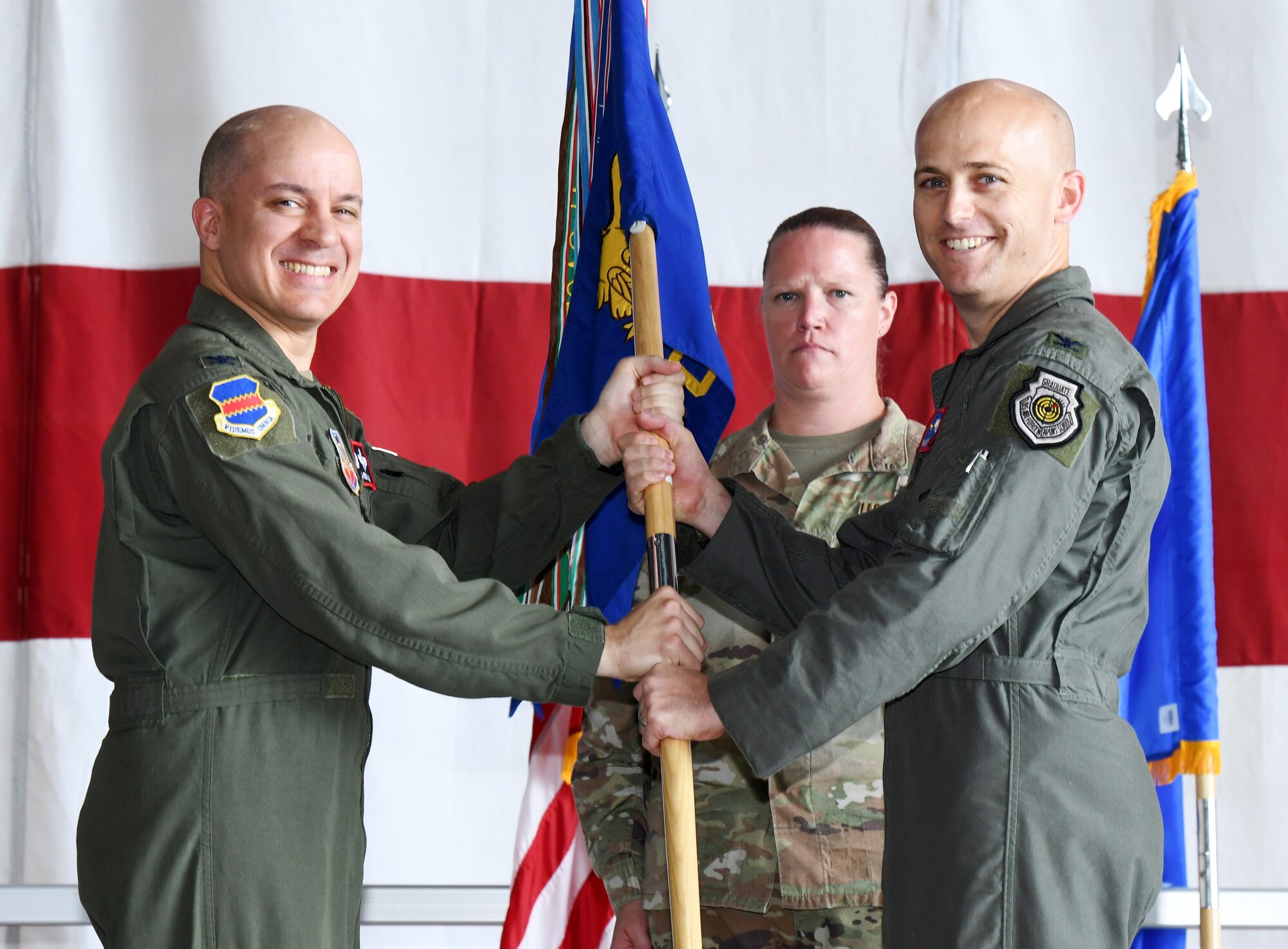 Air Force Col. is receiving a guidon from outgoing commander.