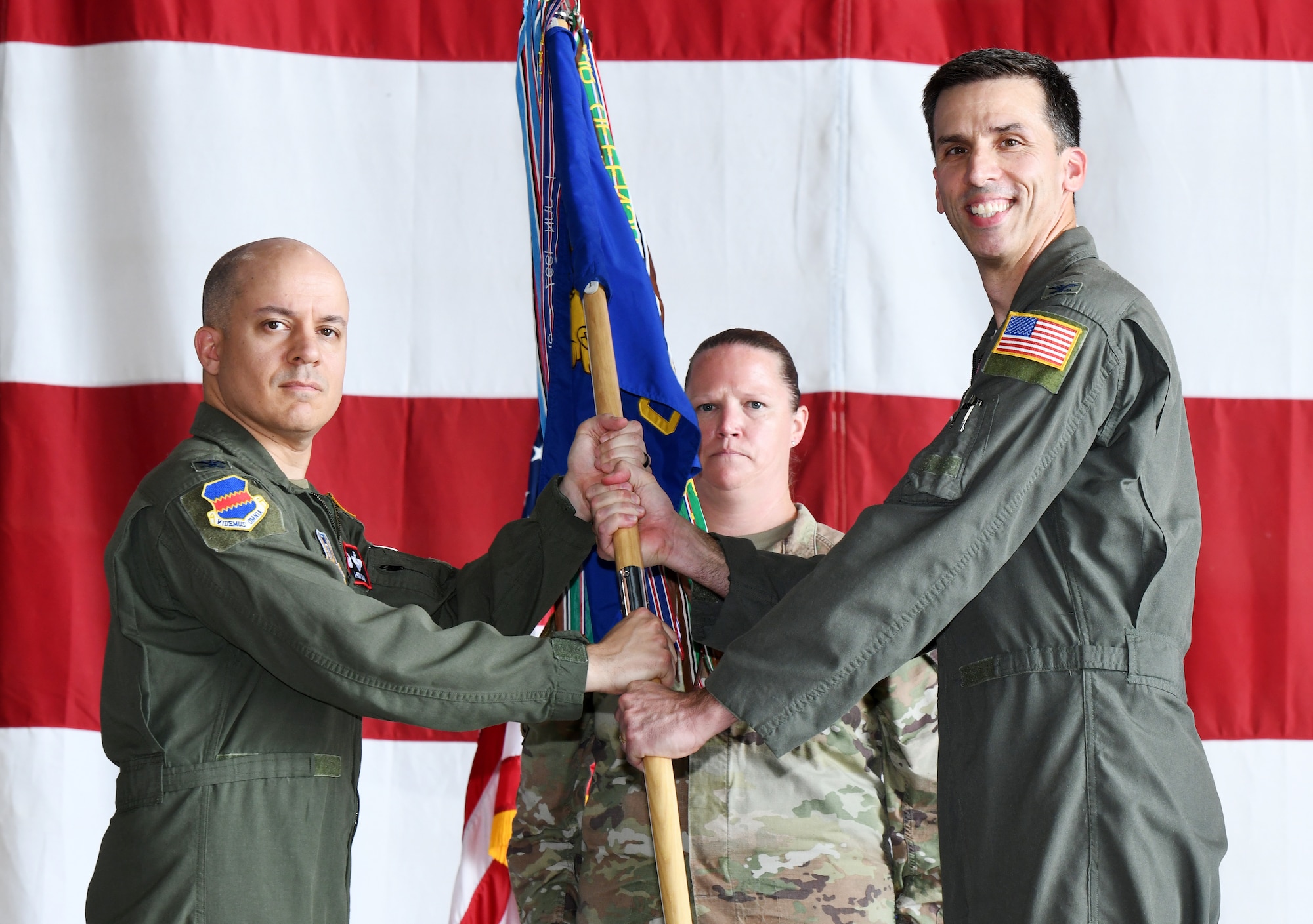 Air Force Col. is receiving a guidon from outgoing commander.