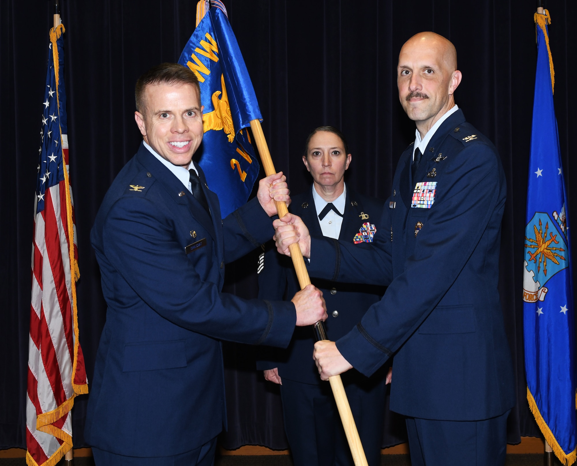 Air Force Colonel receives 2nd Weather Group guidon from outgoing commander.