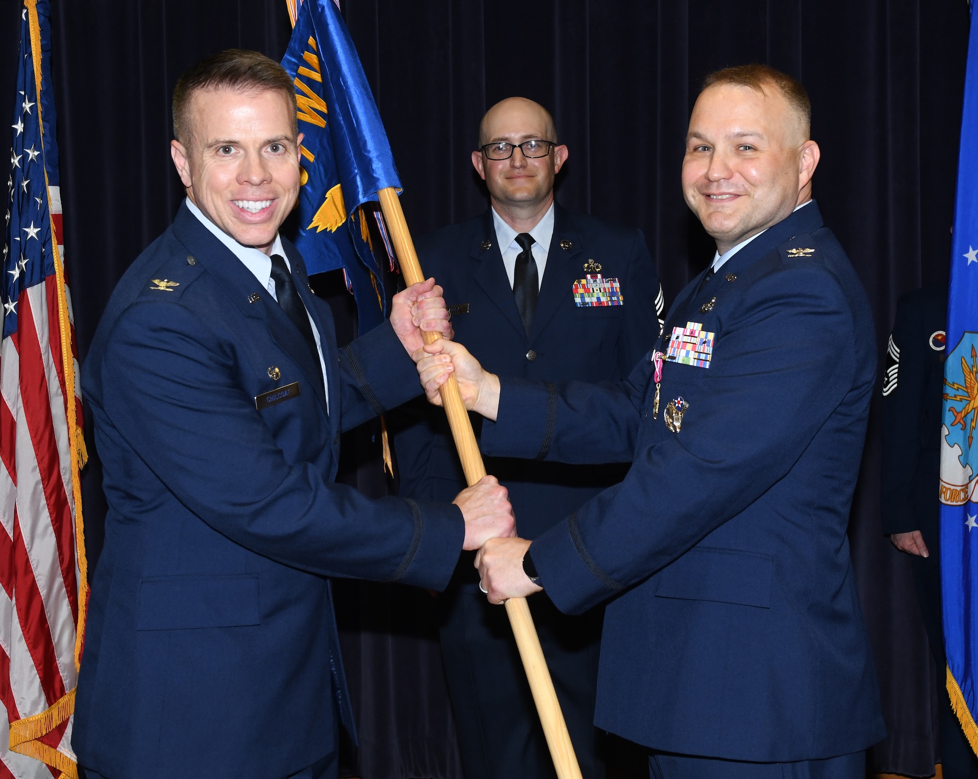 Air Force Colonel receives 2nd Weather Group guidon from outgoing commander.