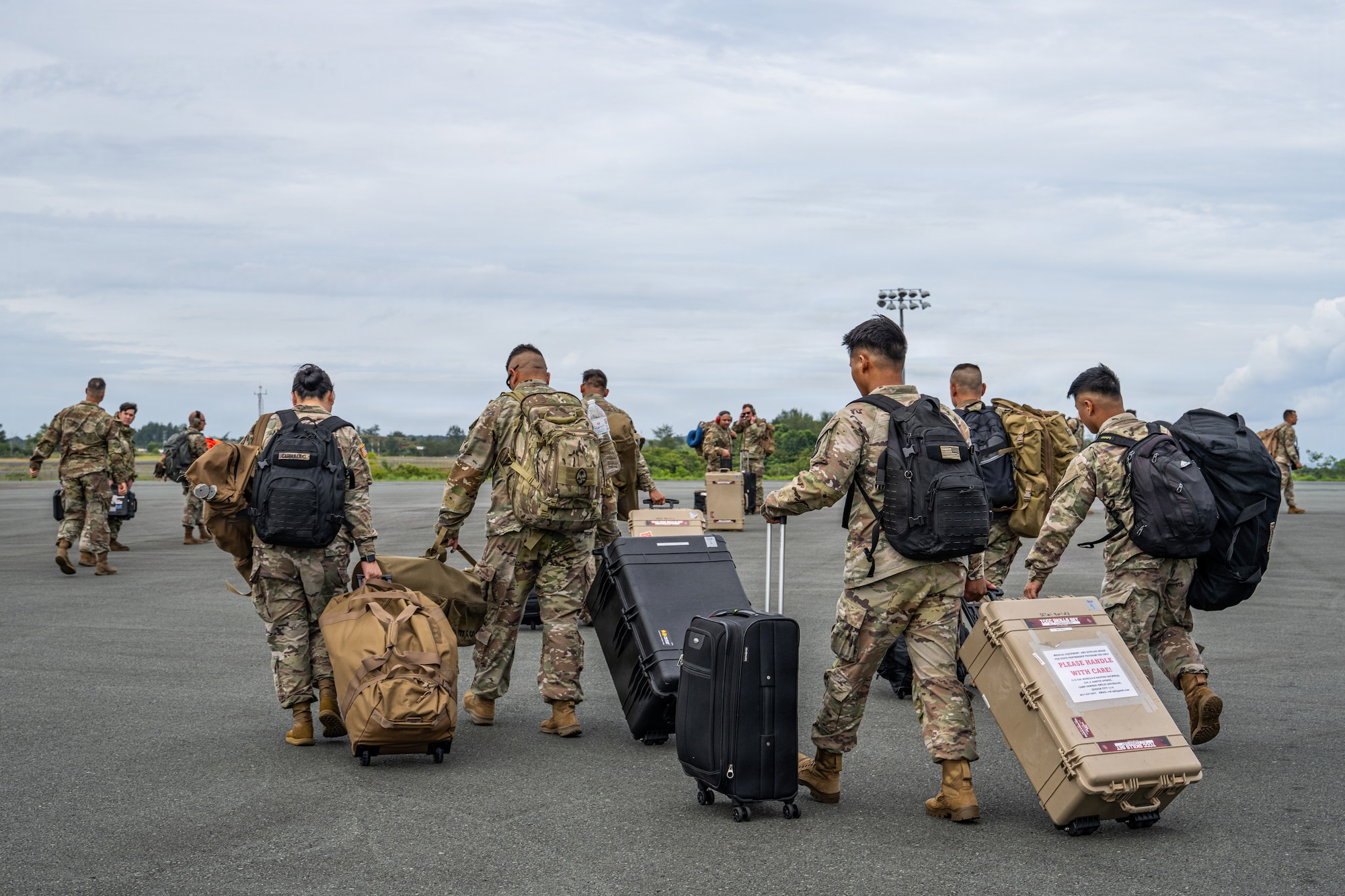 U.S. service members offload from a C-130J Super Hercules at the Palau International Airport, Northern Marian Islands, June 25, 2026, in support of VALIANT SHIELD 2026. Exercises like VALIANT SHIELD allow Pacific Command Joint Forces the opportunity to integrate forces from all branches of service and with our allies to conduct precise, lethal, and overwhelming multi-axis, multi-domain effects that demonstrate the strength and versatility of the joint force and our commitment to a free and open Indo-Pacific. (U.S. Air Force photo by Airman 1st Class Caleb Schellenberg)