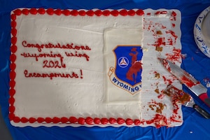 Image of a cake sitting on a table that reads "Congratulations Wyoming Wing 2026 Encampment!"