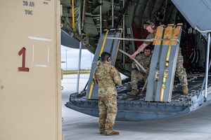 U.S. Airmen secure loading ramps during combat offload Method C training at Anderson Air Force Base, Guam, June 24, 2026, in support of VALIANT SHIELD 2026. Exercises like VALIANT SHIELD allow Pacific Command Joint Forces the opportunity to integrate forces from all branches of service and with our allies to conduct precise, lethal, and overwhelming multi-axis, multi-domain effects that demonstrate the strength and versatility of the joint force and our commitment to a free and open Indo-Pacific. (U.S. Air Force photo by Airman 1st Class Caleb Schellenberg)