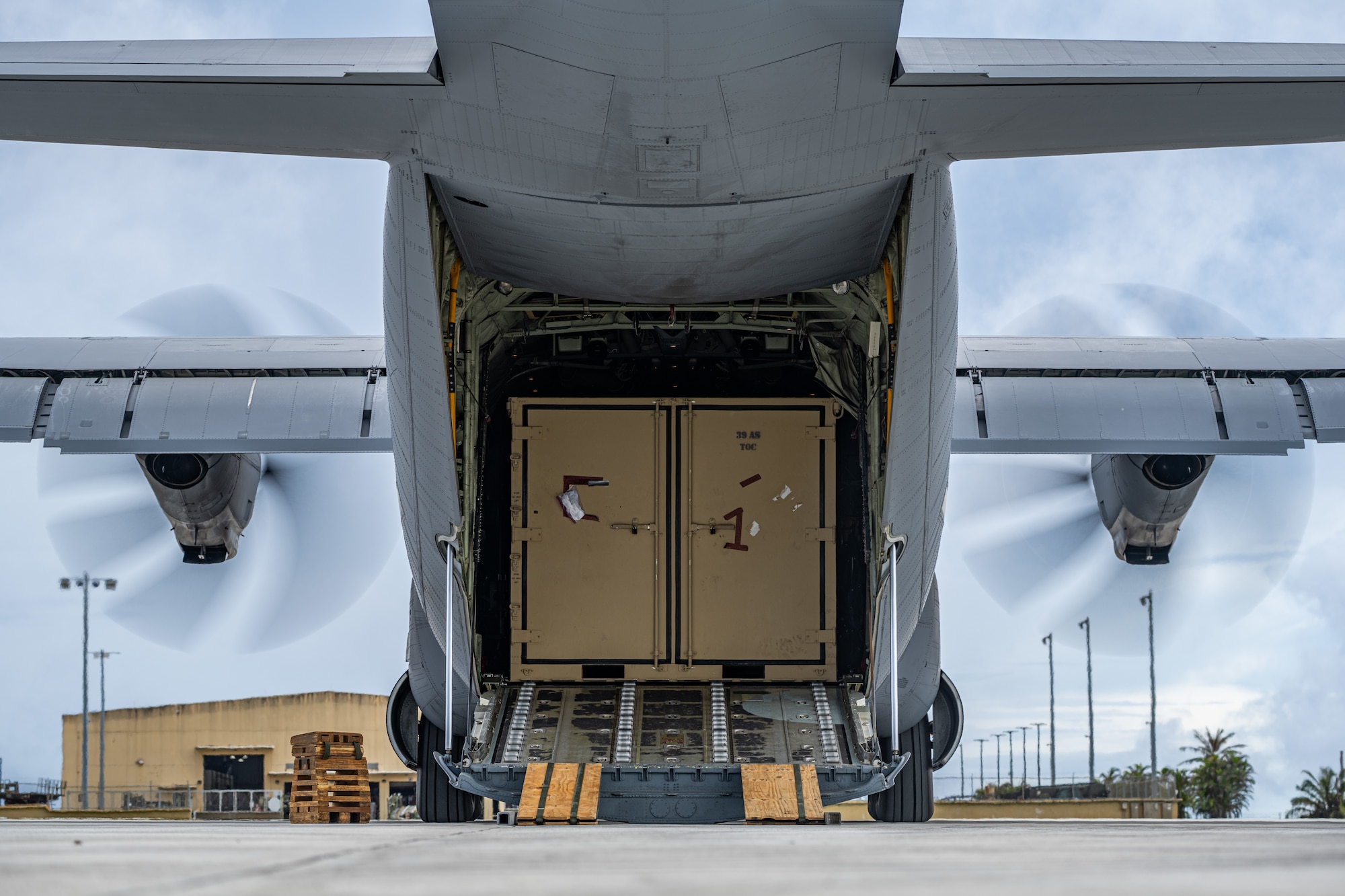 A C-130J Super Hercules is positioned for cargo offload during combat offload Method C training at Andersen Air Force Base, Guam, June 24, 2026, in support of VALIANT SHIELD 2026. Exercises like VALIANT SHIELD allow Pacific Command Joint Forces the opportunity to integrate forces from all branches of service and with our allies to conduct precise, lethal, and overwhelming multi-axis, multi-domain effects that demonstrate the strength and versatility of the joint force and our commitment to a free and open Indo-Pacific. (U.S. Air Force photo by Airman 1st Class Caleb Schellenberg)