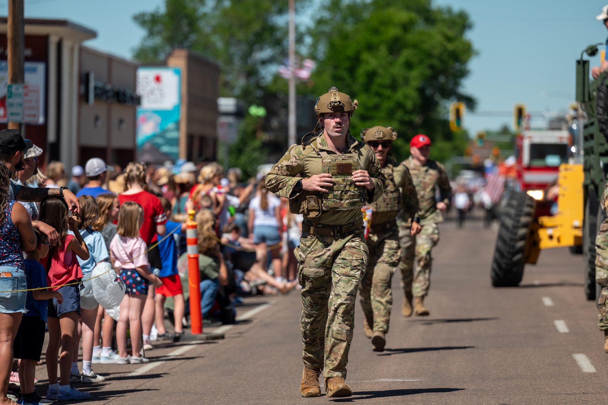 A uniformed man walks during a parade.