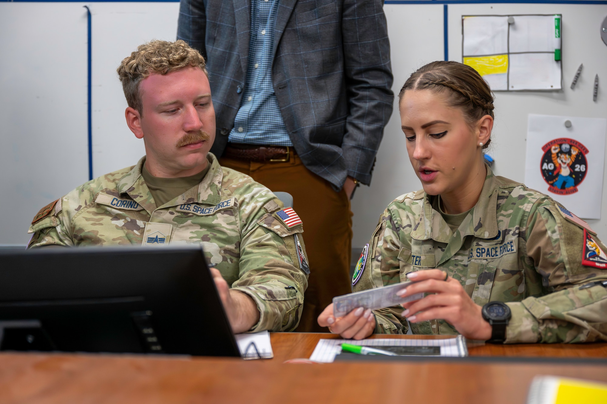 Military members and civilians work at training event.