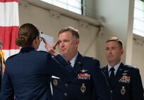 U.S. Air Force Col. James Schlabach, outgoing 91st Missile Wing (91st MW) commander, middle, relinquishes command to U.S. Air Force Maj. Gen. Stacy Jo Huser, 20th Air Force commander, left, during a change of command at Minot Air Force Base, North Dakota, July 8, 2026. Schlabach reflected on the accomplishments of the 91st MW, praising the Airmen and staff that worked under his command for their dedication and work towards the mission of global deterrence. (U.S. Air Force photo by Senior Airman Wesley Davies)