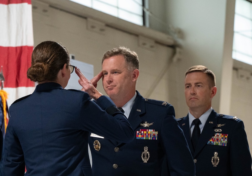 U.S. Air Force Col. James Schlabach, outgoing 91st Missile Wing (91st MW) commander, middle, relinquishes command to U.S. Air Force Maj. Gen. Stacy Jo Huser, 20th Air Force commander, left, during a change of command at Minot Air Force Base, North Dakota, July 8, 2026. Schlabach reflected on the accomplishments of the 91st MW, praising the Airmen and staff that worked under his command for their dedication and work towards the mission of global deterrence. (U.S. Air Force photo by Senior Airman Wesley Davies)