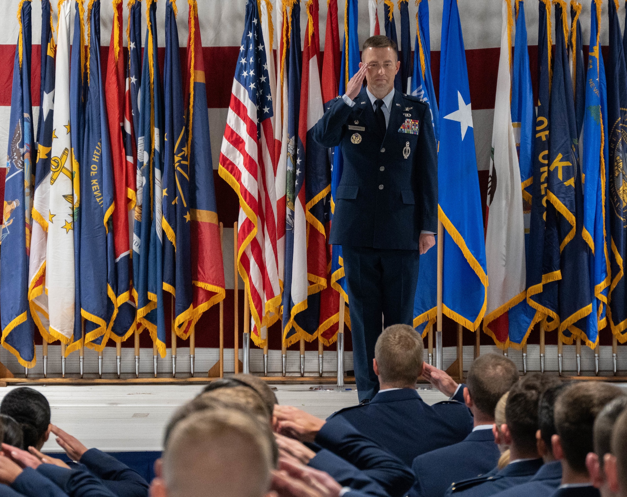 U.S. Air Force Col. George Chapman, incoming 91st Missile Wing (91st MW) commander, renders a salute to a formation of 91st MW Airmen during a change of command ceremony at Minot Air Force Base, North Dakota, July 8, 2026. Chapman was the deputy commander of the 91st MW previously and reflected on the steadfast and lethal force that the 91st MW represents. (U.S. Air Force photo by Airman Benjamin Selchow)