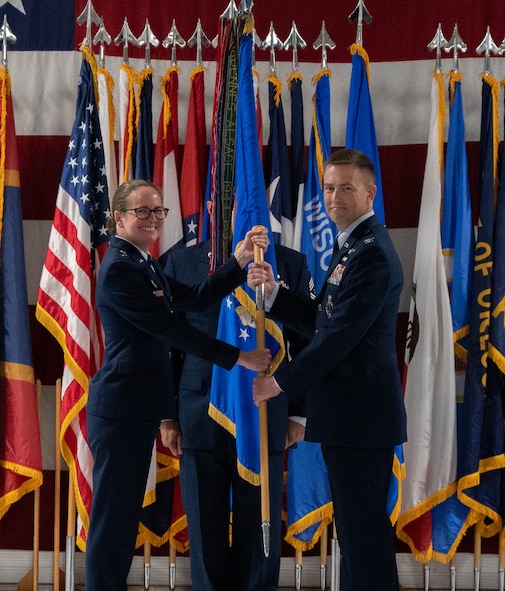 U.S. Air Force Col. George Chapman, incoming 91st Missile Wing (91st MW) commander, right, passes the 91st MW guidon to U.S. Air Force Maj. Gen. Stacy Jo Huser, 20th Air Force commander, left, during a change of command at Minot Air Force Base, North Dakota, July 8, 2026. The 91st MW is one of the Air Force's three operational missile units. The 91st MW maintains a fleet of Minuteman III intercontinental ballistic missiles and its mission is to defend the nation with a combat-ready nuclear force. (U.S. Air Force photo by Airman Benjamin Selchow)